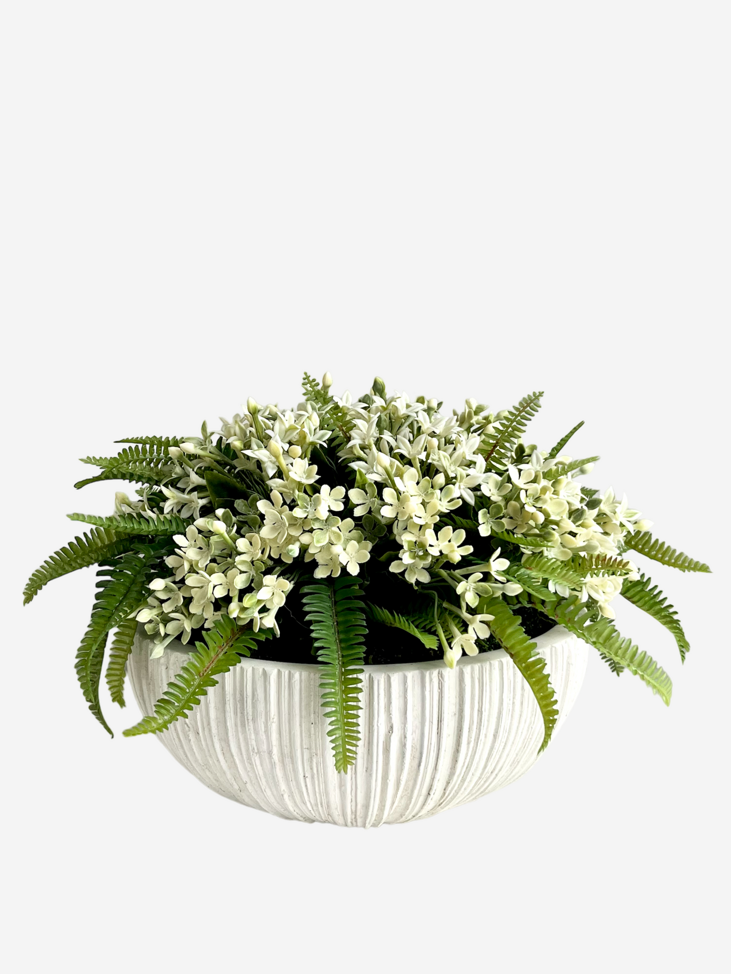 Artificial white jasmine and lush green ferns surrounded by preserved moss in a white ribbed ceramic bowl planter 