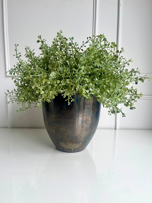 Delicate fresh green artificial button leaf foliage set in a bronze coloured aluminium pot