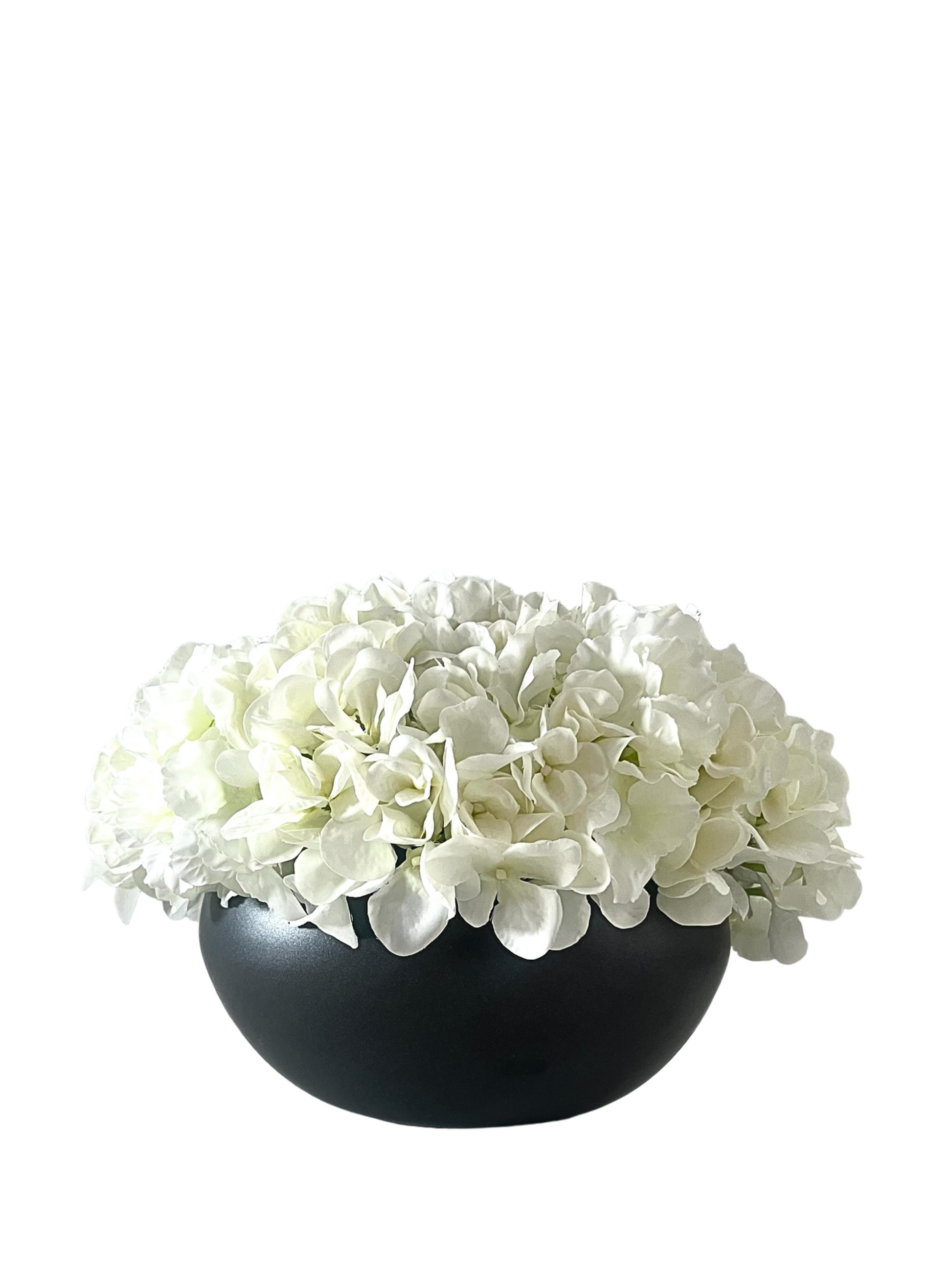 white artificial hydrangea arranged in a black ceramic bowl planter.