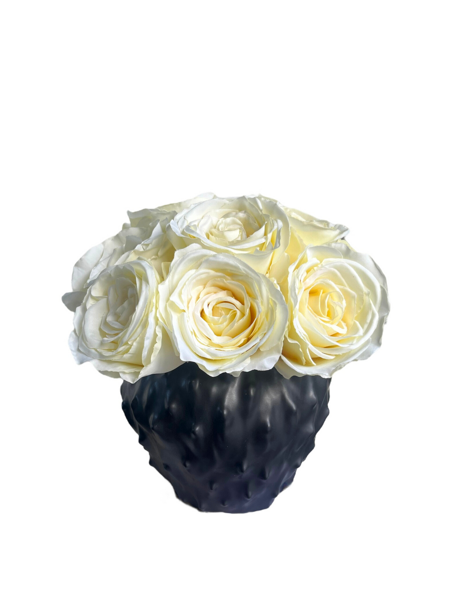 Soft cream artificial roses set in a contemporary spiky black vase.